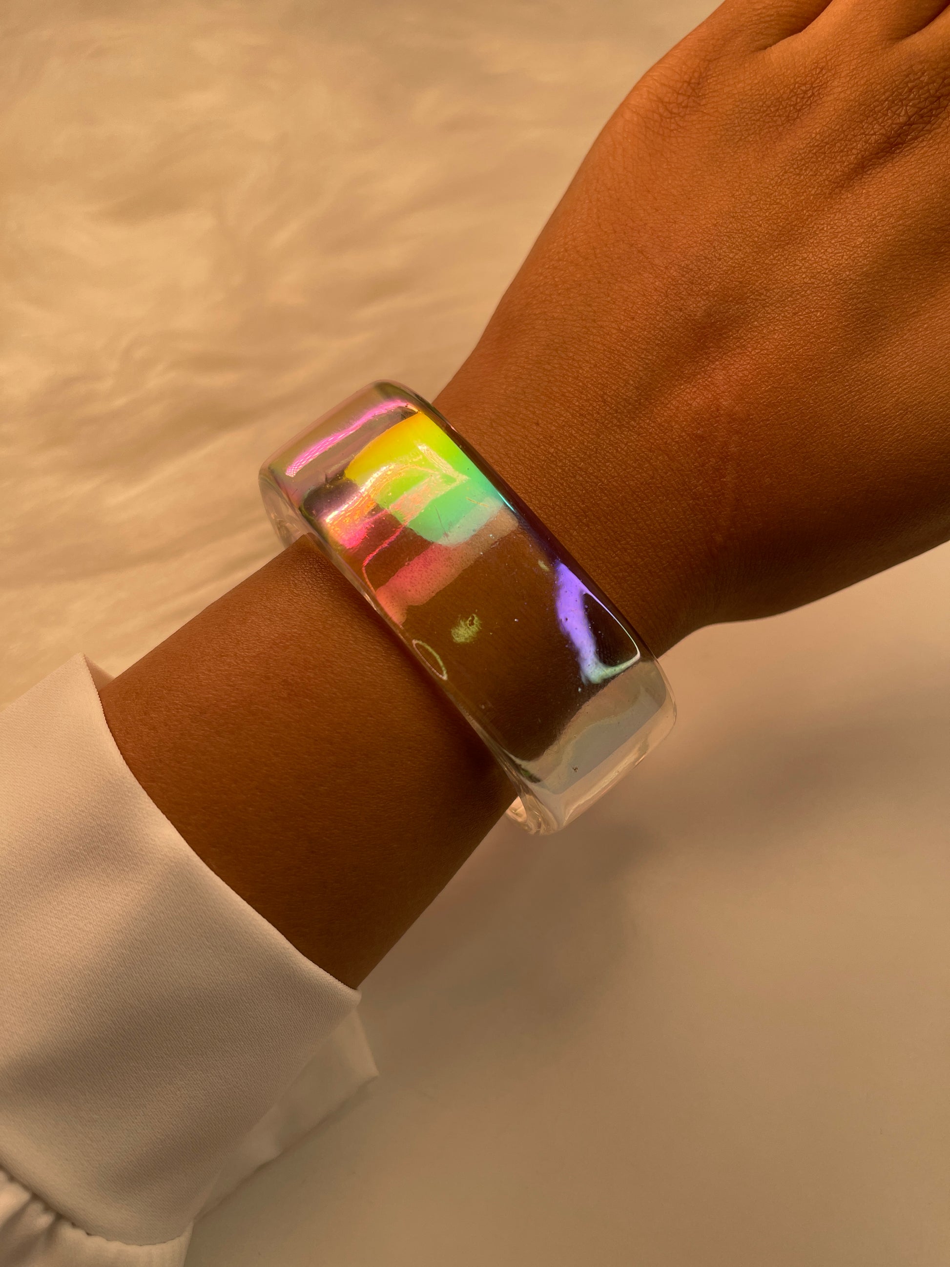 Transparent iridescent bracelet on the wrist 