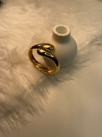 Gold Cuff Bracelet on a textured white surface