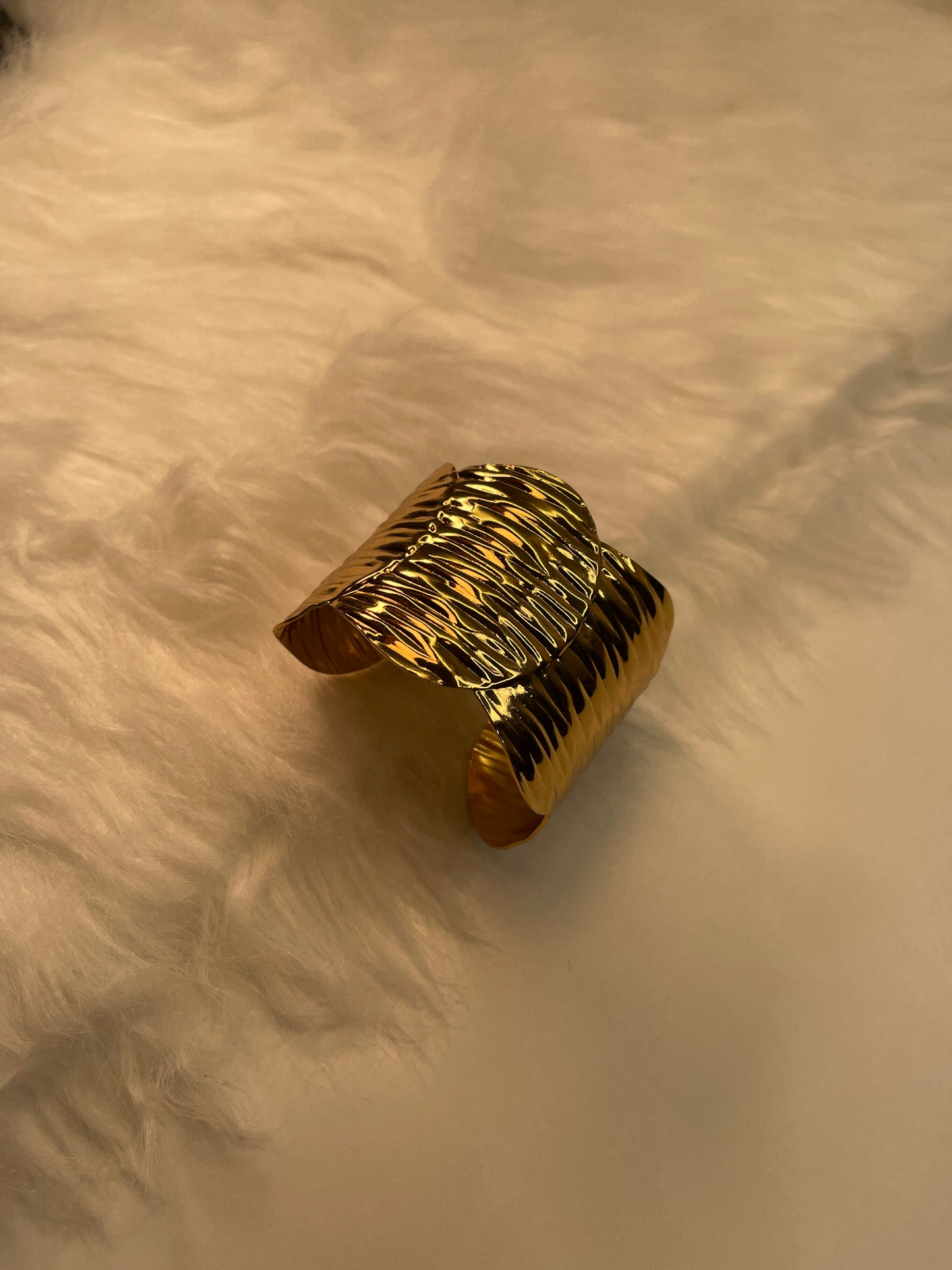 Gold Textured Bracelet on a beige surface