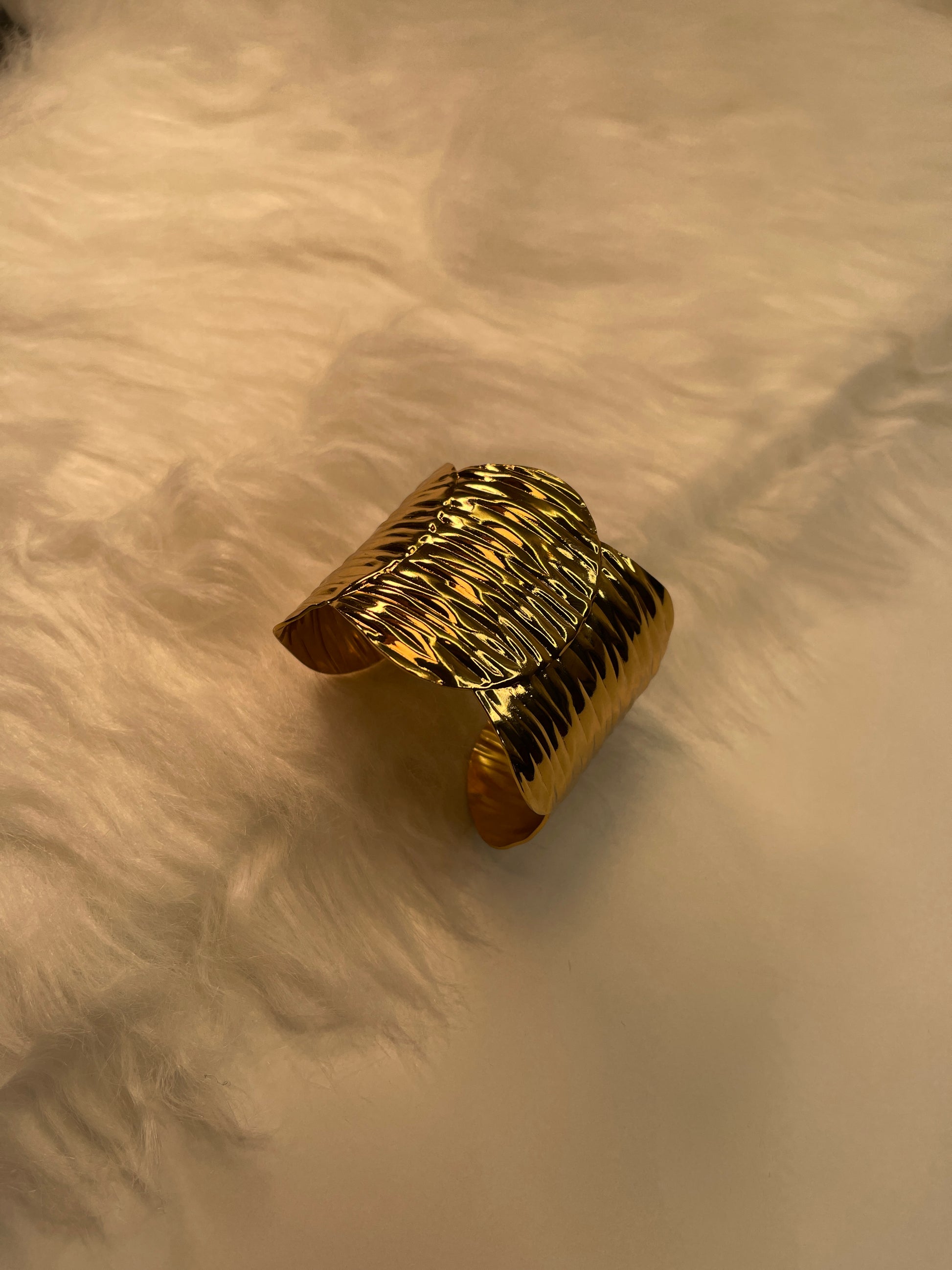 Gold Textured Bracelet on a beige surface